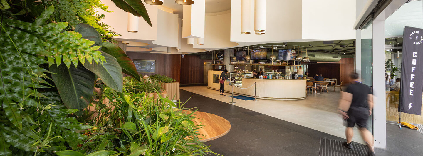 Ground floor of a building with a café in the back